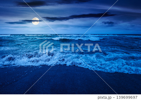 storm on the sandy beach at night. wonderful sea view with cloudy sky. full moon over salt water and crashing waves. mysterious view of bulgaria beach in summer. wind weather background 139699697