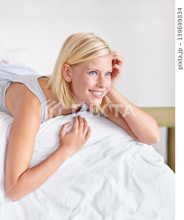 Woman, relax and wake up on bed in morning with happiness, wellness and comfort in home. Calm, girl and lying in bedroom on holiday, vacation and rest for self care in apartment with healthy mindset Woman, relax and wake up on bed in morning with happiness, wellness and comfort in home. Calm, girl and lying in bedroom on holiday, vacation and rest for self care in apartment with healthy mindset 139699834