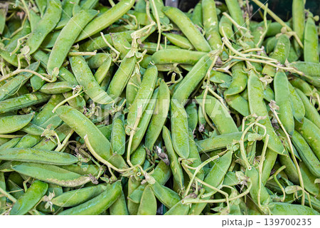 Fresh Green Pea Pods on Market Stall Close Up. Natural organic vegetables Fresh Green Pea Pods on Market Stall Close Up. Natural organic vegetables 139700235