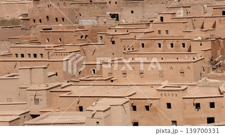 Traditional adobe village architecture with layered earthen homes in a desert landscape. 139700331