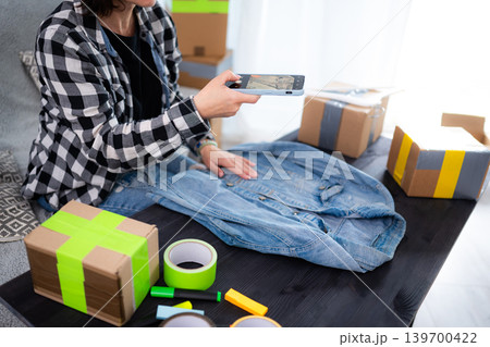 Girl Takes Photos Of Used Clothes And Dress For Selling At Pre-Owned Marketplace 139700422