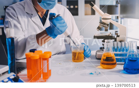 Lab technician experimenting in lab 139700513