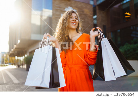 Young woman with shopping bags near mall. Summer Style. Shopping, lifestyle, sale concept. Young woman with shopping bags near mall. Summer Style. Shopping, lifestyle, sale concept. 139700654