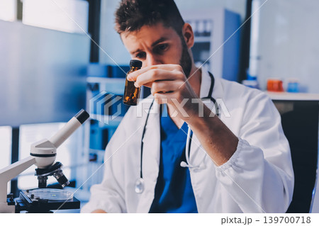 Attractive student of chemistry working in laboratory Attractive student of chemistry working in laboratory 139700718