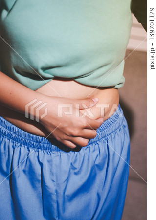 Overweight woman body with hands touching belly fat 139701129