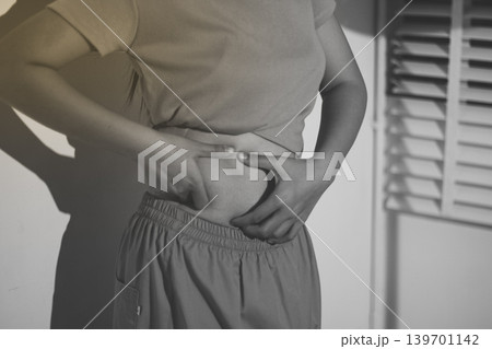 Overweight woman body with hands touching belly fat 139701142