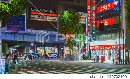 Tokyo, Japan - Oct 14 2024, panoramic view of people crossing road at pedestrian crossing in Ginza district, with many illuminated signage on facades of skyscrapers in background and cars Tokyo, Japan - Oct 14 2024, panoramic view of people crossing road at pedestrian crossing in Ginza district, with many illuminated signage on facades of skyscrapers in background and cars 139702169