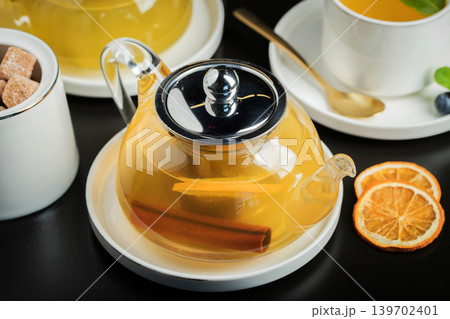 Fruit tea with mango and mint in a glass teapot on the table 139702401