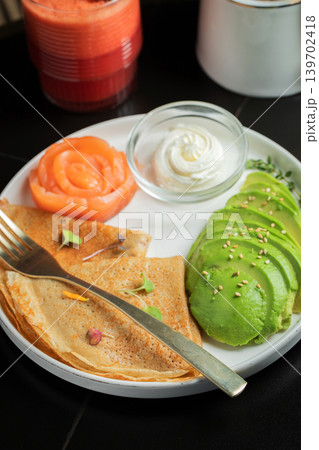 Roasted thin pancakes with smoked salmon and sauce Roasted thin pancakes with smoked salmon and sauce 139702418
