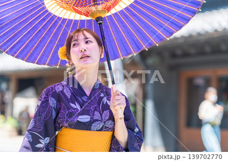 青い和傘と涼しげな浴衣がお似合いの若い日本人女性 青い和傘と涼しげな浴衣がお似合いの若い日本人女性 139702770