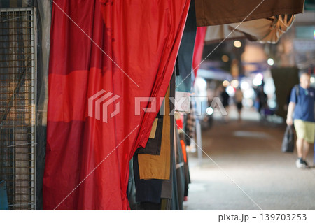 May 15 2026 Red fabric draped outside shop with blurred night street 139703253