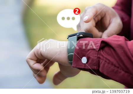 Person interacts with a touchscreen smartwatch for realtime updates, notifications, and modern digital communication using wearable technology. Person interacts with a touchscreen smartwatch for realtime updates, notifications, and modern digital communication using wearable technology. 139703719