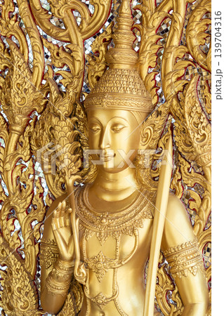 Close view ornate temple door golden thepphanom figure high relief layered carving sacred Thai ornament craftsmanship. Close view ornate temple door golden thepphanom figure high relief layered carving sacred Thai ornament craftsmanship. 139704316
