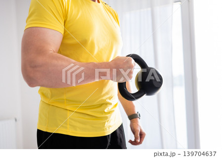 Sporty Man Doing Arm And Shoulder Workout With Dumbbells At Home 139704637