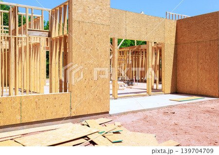 Construction of wooden beams frame building in developing neighborhood Construction of wooden beams frame building in developing neighborhood 139704709
