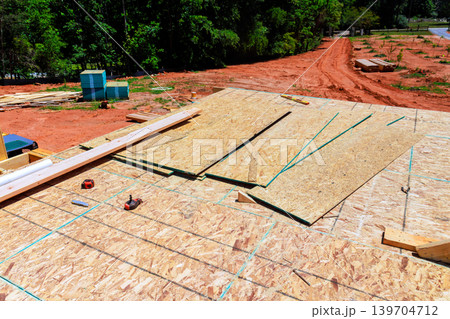 Construction work takes place on new unfinished building site in rural area 139704712