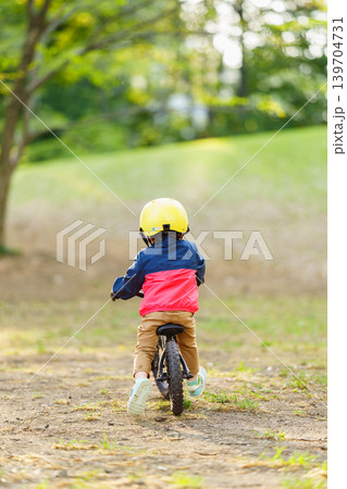 オフロードコースでキックバイクを練習する2歳の男の子 139704731