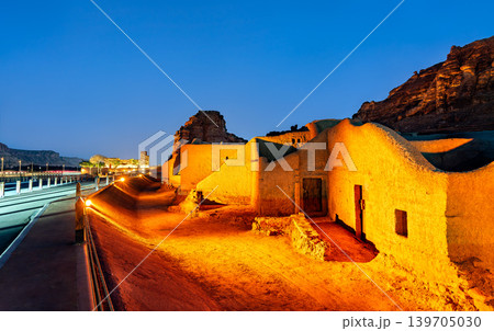 Night view of the illuminated traditional mud-brick houses in the AlUla Old Town, a historic site in the Al Madinah Province of Saudi Arabia. Night view of the illuminated traditional mud-brick houses in the AlUla Old Town, a historic site in the Al Madinah Province of Saudi Arabia. 139705030