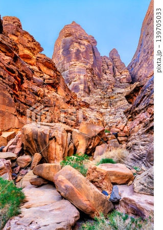 A scenic view of the towering red sandstone rock formations and boulders at the historic Jabal Ikmah site in AlUla, Saudi Arabia. 139705033