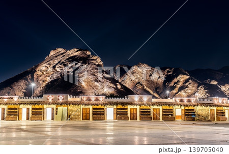 Traditional marketplace buildings at the base of Mount Uhud illuminated at night in Medina, Saudi Arabia. Traditional marketplace buildings at the base of Mount Uhud illuminated at night in Medina, Saudi Arabia. 139705040