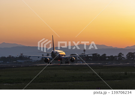 夕暮れの仙台空港 離陸中の飛行機と夕日 宮城県名取市 夕暮れの仙台空港 離陸中の飛行機と夕日 宮城県名取市 139706234