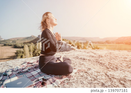 Woman Meditating on a Mountaintop Woman Meditating on a Mountaintop 139707181