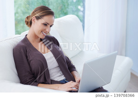 Woman, laptop and relax on sofa for remote work, update blog post and digital news on social media at home. Happy freelancer, computer and person on house living room couch with website technology 139708366