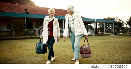 Retirement, hobby and senior woman friends walking on a field at the bowls club together for a leisure activity. Smile, talking and elderly people on the green of a course for bonding or recreation Retirement, hobby and senior woman friends walking on a field at the bowls club together for a leisure activity. Smile, talking and elderly people on the green of a course for bonding or recreation 139708393