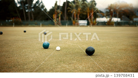 Green, lawn bowling and balls on grass, field or pitch in a match, game or competition of outdoor bowls. Ball, sport and tournament at a bowlers club, league or championship games on the ground 139708431