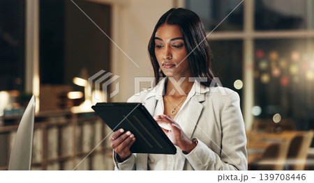 Night, tablet and business woman typing, scroll and manager review journalist story, social media blog and working late. Professional news reporter, reading and Indian person check online article 139708446