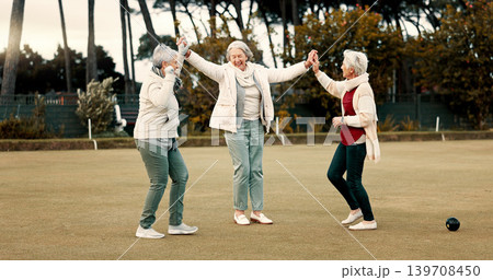 Senior women, celebration and park for sport, lawn bowling and happy for fitness, goal or applause in nature. Teamwork, elderly lady friends and metal ball for games, contest or win together on grass Senior women, celebration and park for sport, lawn bowling and happy for fitness, goal or applause in nature. Teamwork, elderly lady friends and metal ball for games, contest or win together on grass 139708450