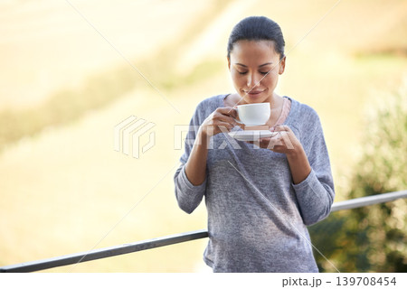 Woman, coffee and relax on balcony outdoor, aroma and warm beverage with morning routine and zen in nature. Peace, mockup and espresso for caffeine or happiness with smile and tea cup in countryside Woman, coffee and relax on balcony outdoor, aroma and warm beverage with morning routine and zen in nature. Peace, mockup and espresso for caffeine or happiness with smile and tea cup in countryside 139708454