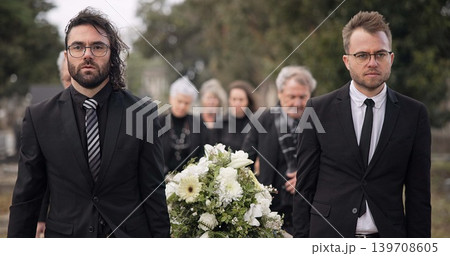 Pallbearers, men and walking with coffin at graveyard ceremony outdoor at burial place. Death, grief and group of people with casket at cemetery for funeral and family service while mourning at event 139708605