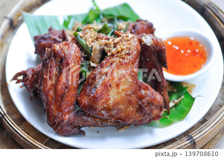 fried chick with fried garlic or chicken wings or deep fried chicken , fried chicken and sauce fried chick with fried garlic or chicken wings or deep fried chicken , fried chicken and sauce 139708610