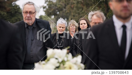 Pallbearers, men and walking with coffin in funeral, ceremony or mourning event at graveyard with sad, grief and flowers. People, support and walk with family in memorial service together with casket Pallbearers, men and walking with coffin in funeral, ceremony or mourning event at graveyard with sad, grief and flowers. People, support and walk with family in memorial service together with casket 139708643