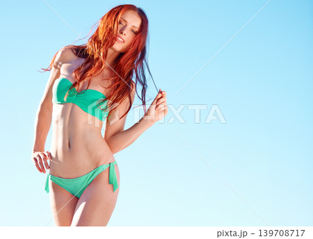Portrait, bikini and hair of ginger woman outdoor for vacation, holiday or summer travel on trip by blue sky mockup space. Redhead, young person and swimsuit of confident girl, beauty and body health 139708717