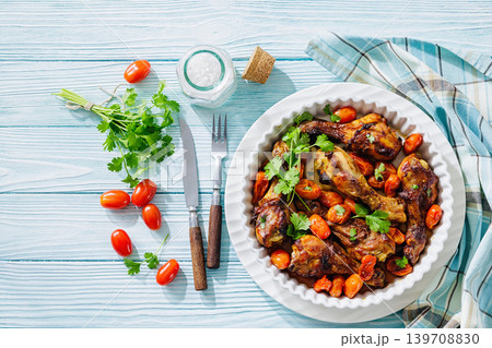 Roasted chicken drumsticks with tomatoes in a dish Roasted chicken drumsticks with tomatoes in a dish 139708830