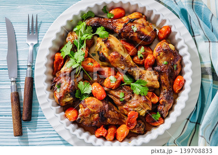 Roasted chicken drumsticks with tomatoes in a dish Roasted chicken drumsticks with tomatoes in a dish 139708833