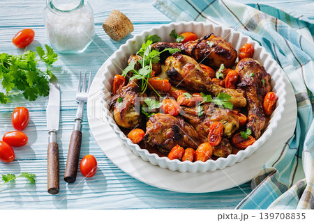 Roasted chicken drumsticks with tomatoes in a dish Roasted chicken drumsticks with tomatoes in a dish 139708835