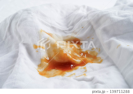 Dirty tomato sauce stain or ketchup on cloth to wash with washing powder, cleaning housework. Dirty tomato sauce stain or ketchup on cloth to wash with washing powder, cleaning housework. 139711288