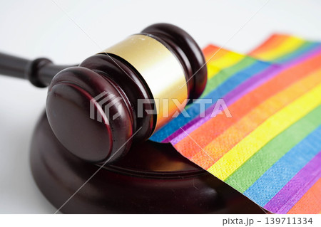 Gavel for judge lawyer on rainbow flag, symbol of LGBT pride month. Gavel for judge lawyer on rainbow flag, symbol of LGBT pride month. 139711334