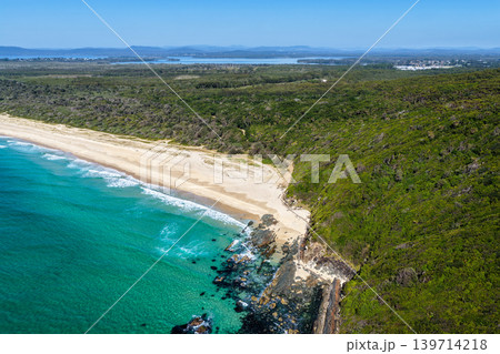 Aerial view of Seven Mile Beach in Forster NSW Australia. Drone photograph captures the expansive sandy shoreline, rolling ocean waves and scenic coastal landscape Aerial view of Seven Mile Beach in Forster NSW Australia. Drone photograph captures the expansive sandy shoreline, rolling ocean waves and scenic coastal landscape 139714218