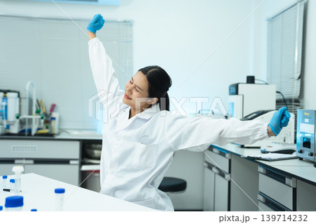 two scientists is doing a stretchy posture due from working in research lab for too long. two scientists is doing a stretchy posture due from working in research lab for too long. 139714232