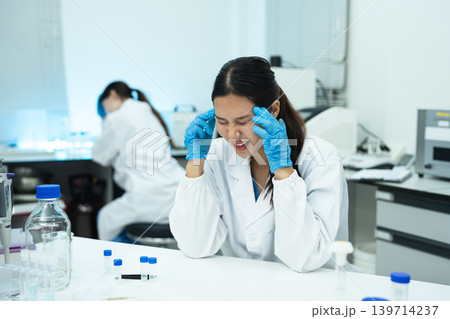 two scientists are under stress from working in research lab. two scientists are under stress from working in research lab. 139714237