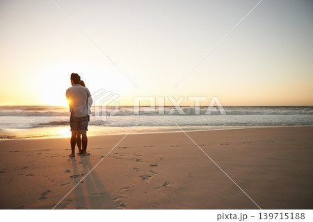Couple, hug and beach sunset for summer travel or adventure, bonding or marriage. People, love and embrace at ocean water for dating tourism or back view for nature vacation, mockup or holiday Couple, hug and beach sunset for summer travel or adventure, bonding or marriage. People, love and embrace at ocean water for dating tourism or back view for nature vacation, mockup or holiday 139715188