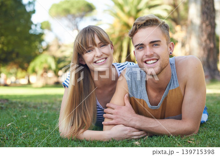 Couple, smile in portrait and relax on grass in park, love and commitment in healthy relationship with picnic outdoor. Happy, care and trust with people in nature or public garden for romantic date 139715398