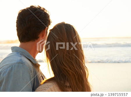 Sunset, love and back of couple at beach on vacation, adventure or holiday for valentines day. Outdoor, travel and man and woman watching ocean for tropical weekend trip on romantic anniversary date. Sunset, love and back of couple at beach on vacation, adventure or holiday for valentines day. Outdoor, travel and man and woman watching ocean for tropical weekend trip on romantic anniversary date. 139715557