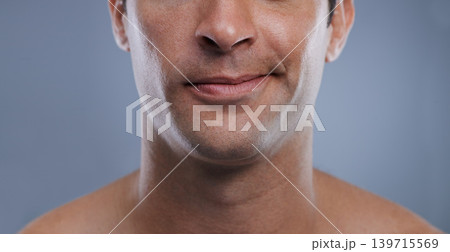Man, mouth and smirk with face and lips for hygiene, jawline, and unhappy for treatment closeup. Grooming, mockup space and skincare with male model in studio background for clean cosmetics zoom Man, mouth and smirk with face and lips for hygiene, jawline, and unhappy for treatment closeup. Grooming, mockup space and skincare with male model in studio background for clean cosmetics zoom 139715569