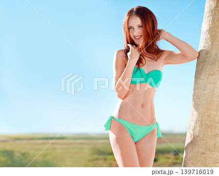 Smile, bikini and redhead woman outdoor in nature by tree for vacation, holiday or summer travel on sky mockup space. Style, happy young person in swimsuit and girl thinking of beauty or body health Smile, bikini and redhead woman outdoor in nature by tree for vacation, holiday or summer travel on sky mockup space. Style, happy young person in swimsuit and girl thinking of beauty or body health 139716019