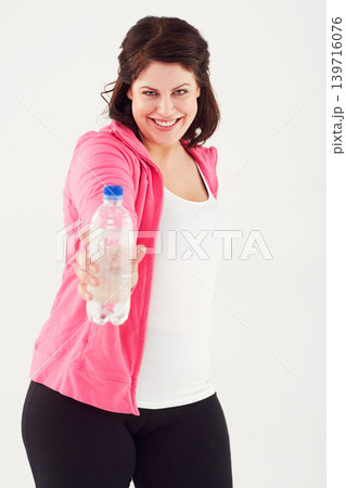 Happy woman, portrait and plus size with bottle of water in fitness for natural nutrition on a white studio background. Face of female person smile with mineral drink for sustainability or hydration Happy woman, portrait and plus size with bottle of water in fitness for natural nutrition on a white studio background. Face of female person smile with mineral drink for sustainability or hydration 139716076